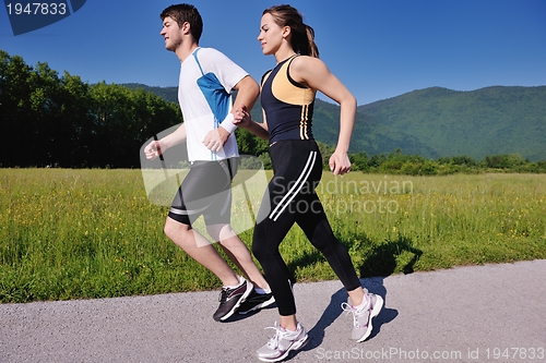 Image of Young couple jogging