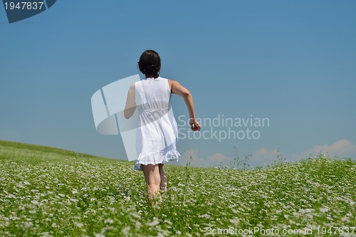 Image of Young happy woman in green field