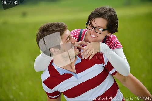 Image of Portrait of romantic young couple smiling together outdoor