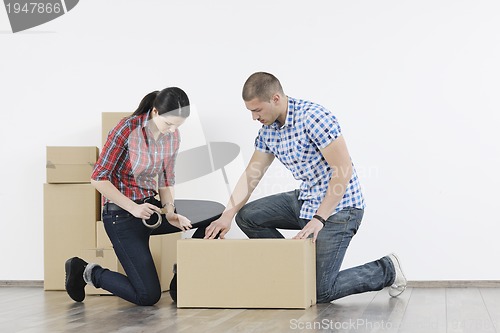 Image of Young couple moving in new home