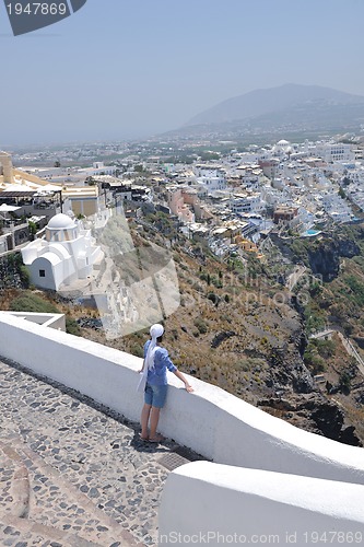 Image of Greek woman on the streets of Oia, Santorini, Greece