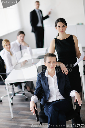 Image of business woman with her staff in background