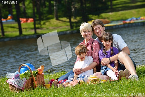 Image of Happy family playing together in a picnic outdoors