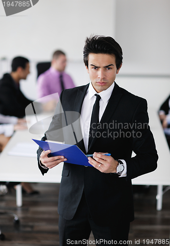 Image of young business man at meeting