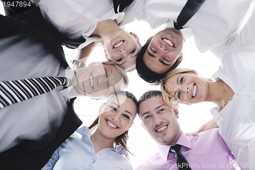 Image of business people with their heads together