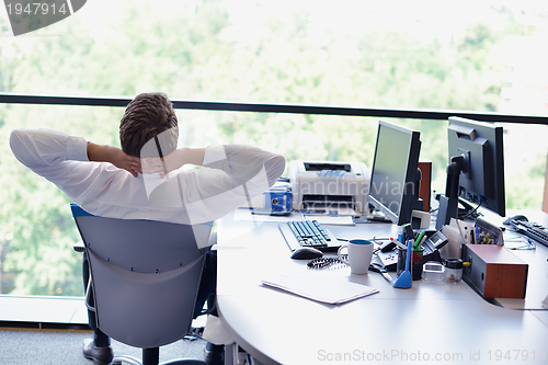 Image of happy young business man at office