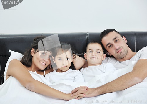 Image of happy young Family in their bedroom