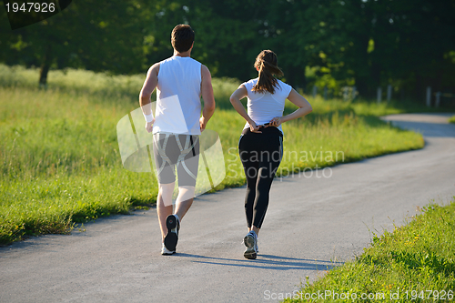 Image of Young couple jogging at morning