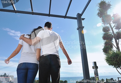 Image of couple relaxing on balcony