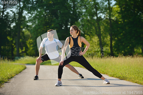 Image of Couple doing stretching exercise  after jogging