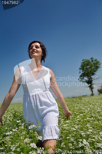 Image of Young happy woman in green field