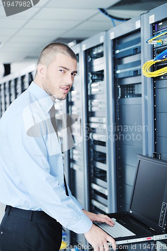 Image of young it engeneer in datacenter server room