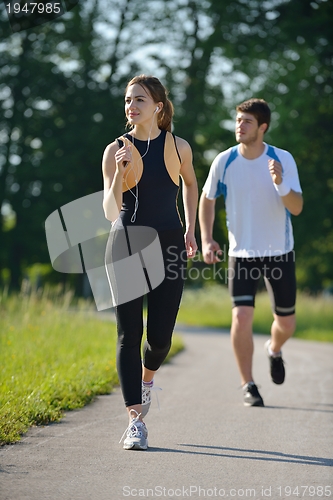 Image of Young couple jogging at morning