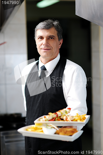 Image of male chef presenting food