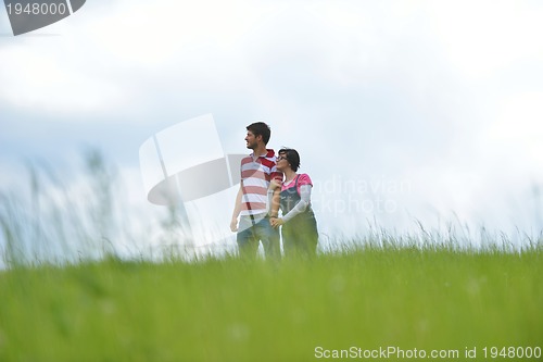 Image of Portrait of romantic young couple smiling together outdoor