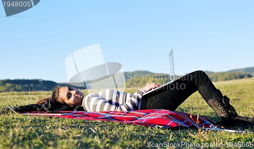 Image of young teen girl work on laptop outdoor