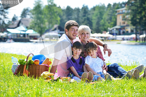 Image of Happy family playing together in a picnic outdoors