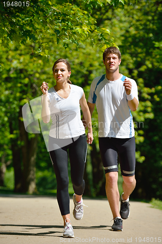 Image of Young couple jogging