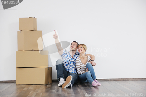 Image of Young couple moving in new home