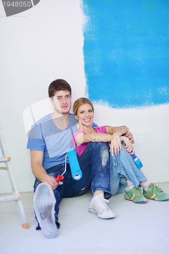 Image of happy young cople relaxing after painting in new home