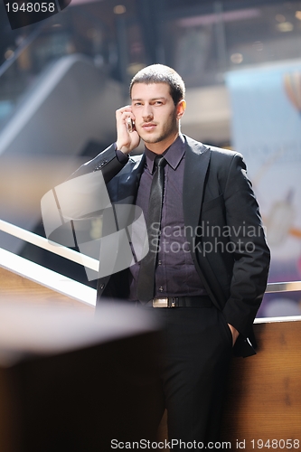 Image of young business man talking by cell phone