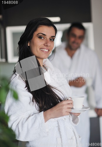 Image of Young love couple taking fresh morning cup of coffee