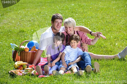 Image of Happy family playing together in a picnic outdoors