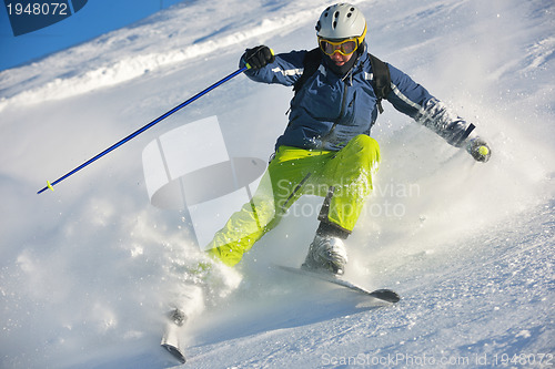 Image of skiing on fresh snow at winter season at beautiful sunny day