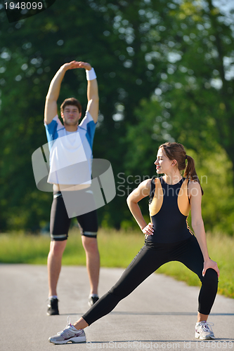 Image of Couple doing stretching exercise  after jogging