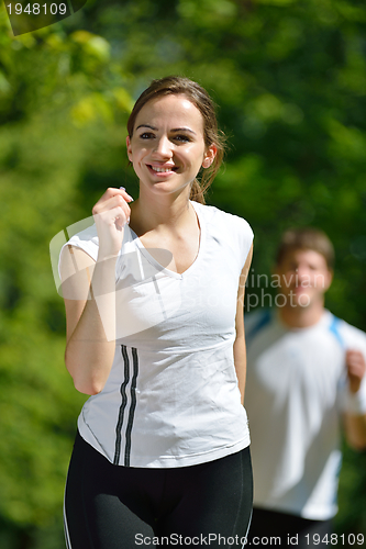 Image of Young couple jogging at morning