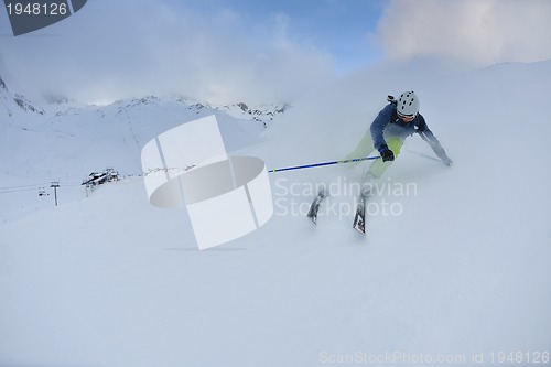 Image of skiing on fresh snow at winter season at beautiful sunny day