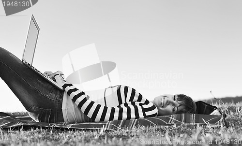 Image of young teen girl work on laptop outdoor