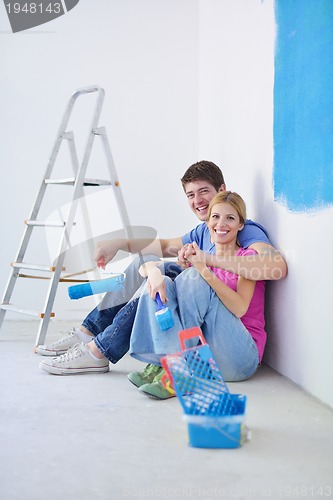 Image of happy young cople relaxing after painting in new home