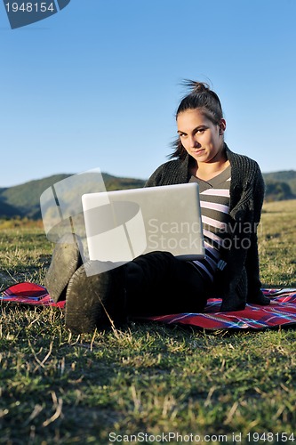 Image of young teen girl work on laptop outdoor