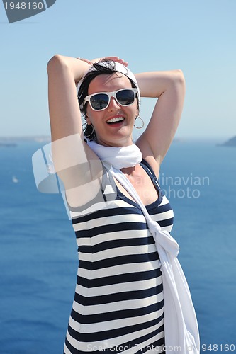 Image of Greek woman on the streets of Oia, Santorini, Greece