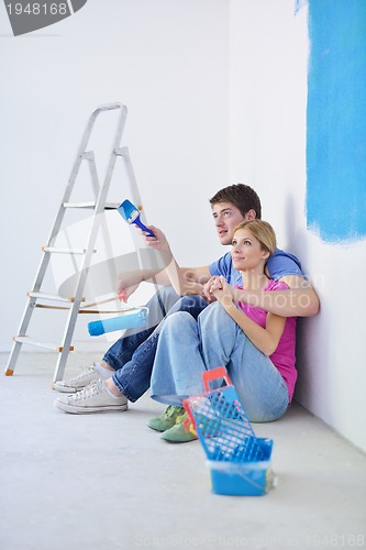 Image of happy young cople relaxing after painting in new home