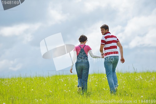 Image of Portrait of romantic young couple smiling together outdoor