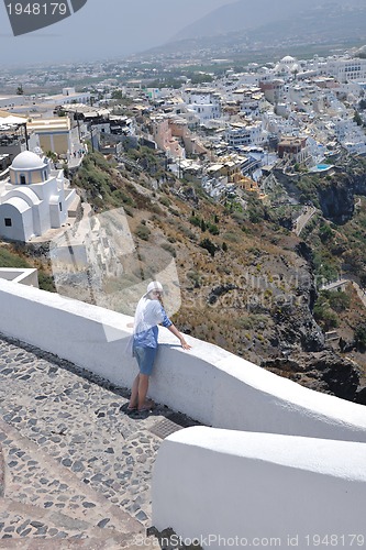 Image of Greek woman on the streets of Oia, Santorini, Greece