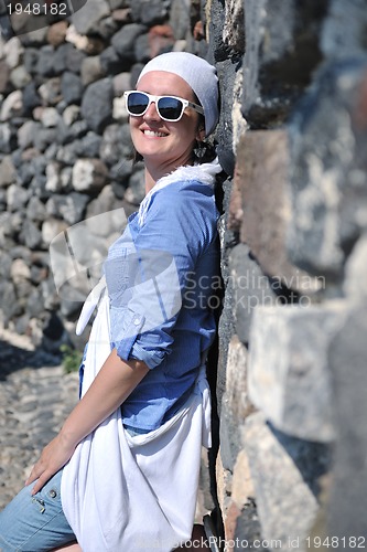 Image of Greek woman on the streets of Oia, Santorini, Greece