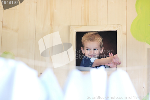 Image of happy child in a window