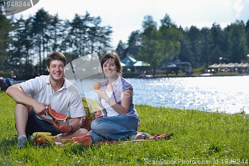 Image of happy young couple having a picnic outdoor