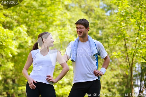 Image of Couple doing stretching exercise  after jogging