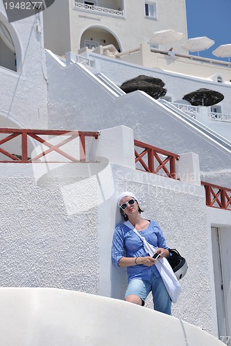 Image of Greek woman on the streets of Oia, Santorini, Greece