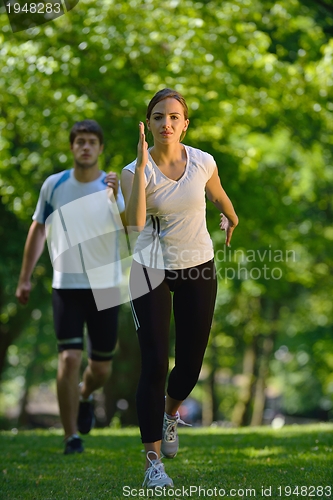 Image of Young couple jogging