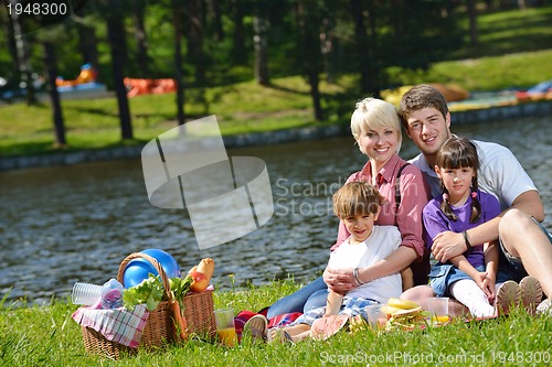 Image of Happy family playing together in a picnic outdoors