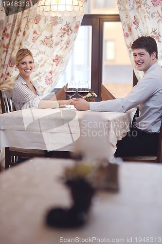 Image of young couple having dinner at a restaurant