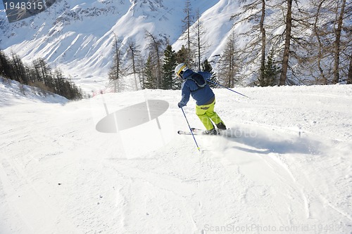 Image of skiing on fresh snow at winter season at beautiful sunny day