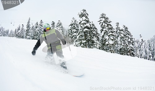 Image of snowboarder on fresh deep snow