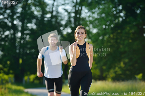 Image of Young couple jogging at morning