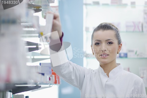 Image of pharmacist chemist woman standing in pharmacy drugstore